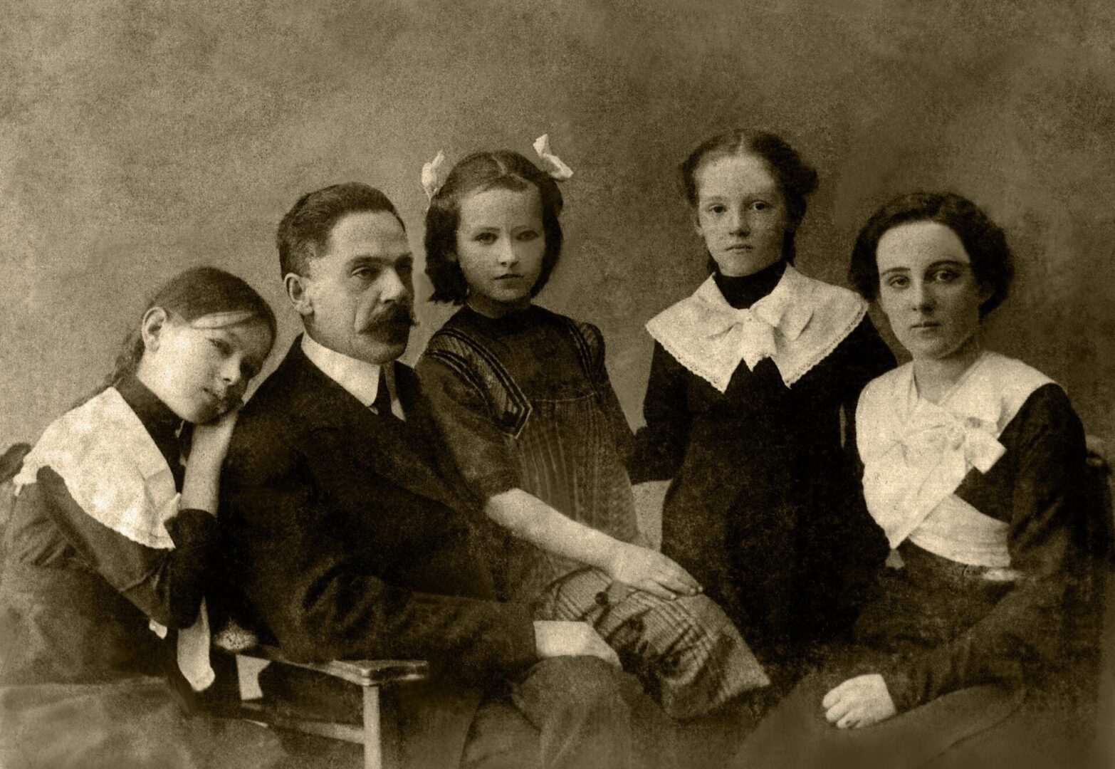 A family of five posing for the camera.